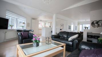 Standard Apartment | Living room | 30-inch flat-screen TV with satellite channels