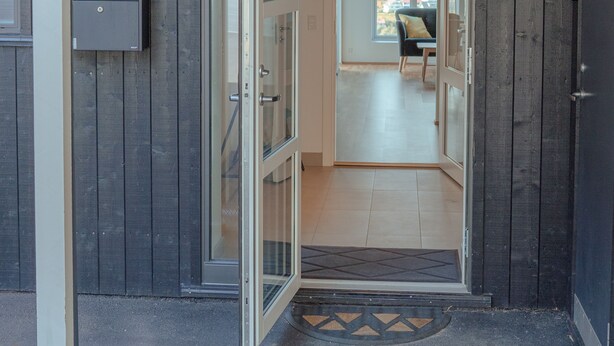 A wooden exterior with a glass door entrance, a mailbox, and a view of the interior. - Breathtaking Views - New - 220M2 - 5 Br - Walks (Argir)