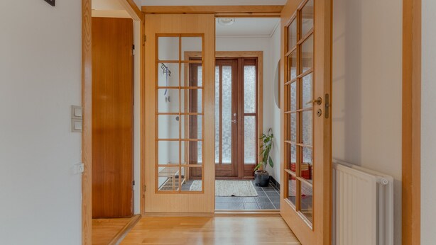 A hallway with wooden doors and a radiator. - Unique Location - Bodanes - Hoydalar - 6 Br Villa (Hoyvík)