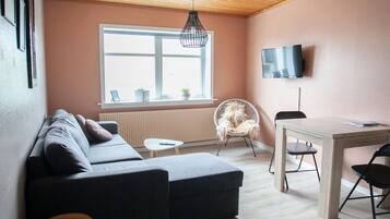 Apartment | Living area | 30-inch flat-screen TV with satellite channels