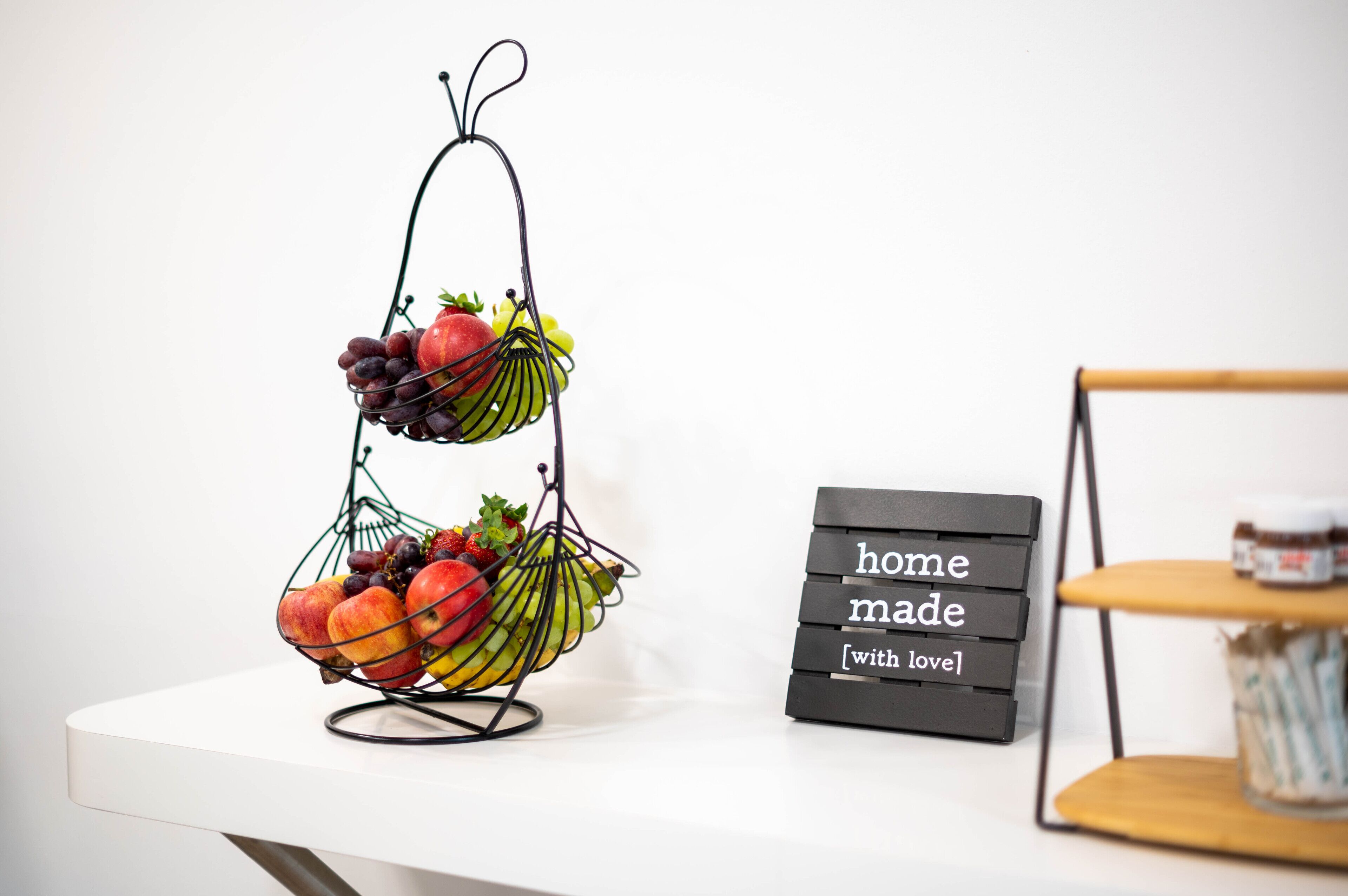 A fruit basket on a stand with a sign saying "home made [with love]".