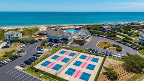 A coastal residential area with a beach, a swimming pool, and a parking lot. - Moonshadow: Oceanfront, walkway to the beach, hot tub, awesome ocean views! (Nags Head)