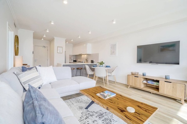 Smart TV in a bright open-plan living and dining space.