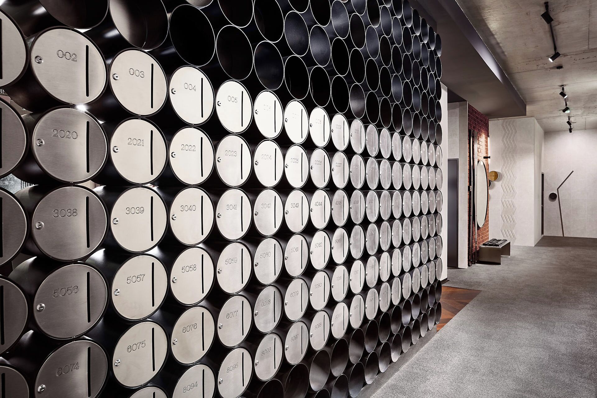 A wall of wine barrels with numbers indicating different vintages.