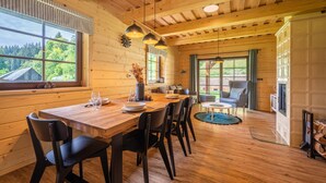 A wooden interior with a dining table set for four, a sofa, and a TV. - Velk Karlovice Mkr545 (Velké Karlovice)