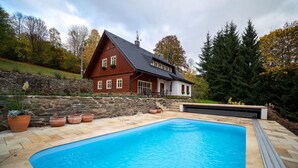 A house with a swimming pool, stone wall, and potted plants. - Vysoke nad Jizerou Kkh070 (Vysoké nad Jizerou)