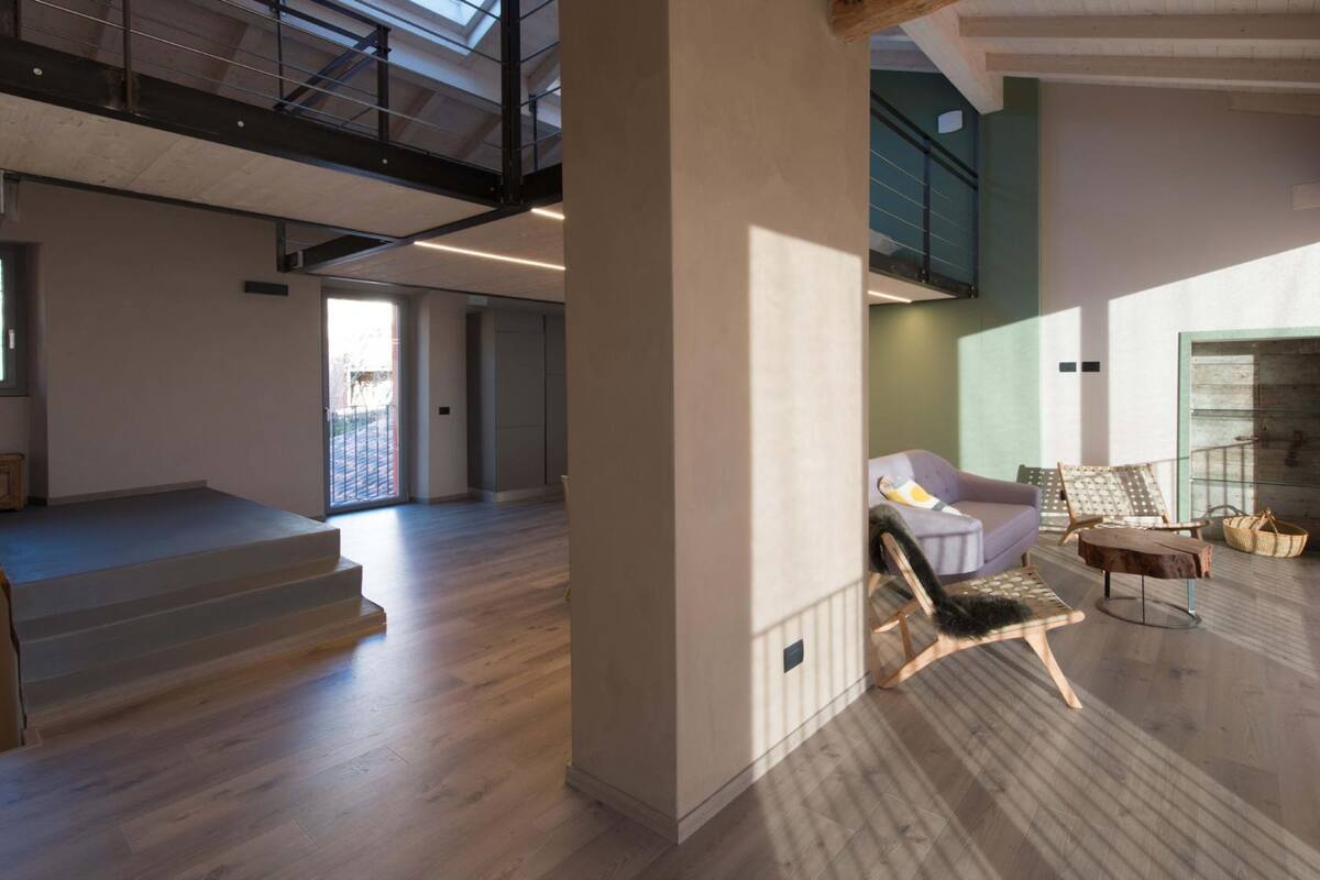 A spacious living area with a staircase, a sofa, and a coffee table.