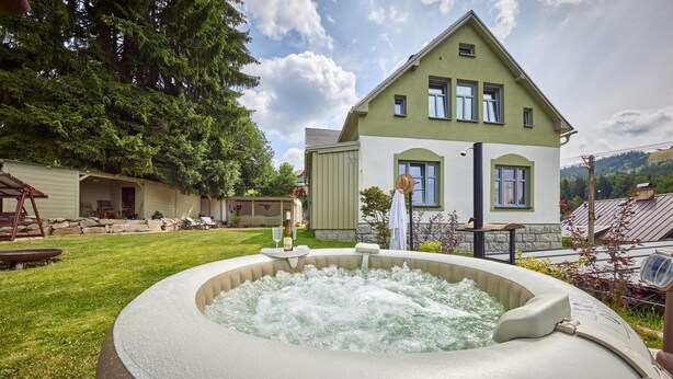 A hot tub in a backyard with a house in the background. - Albrechtice Lat085 in Albrechtice v Jizersk ch hor ch (Albrechtice v Jizerských horách)