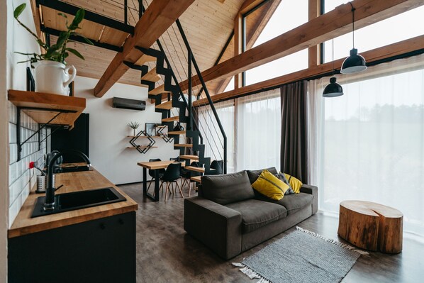 A modern kitchen with a wooden countertop, a sink, and a staircase leading to a loft area. - Pernstejn Vpm019 in B Ovec (Býšovec)
