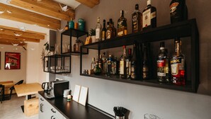 A bar area with shelves of liquor bottles, a coffee machine, and a menu board. - Pernstejn Vpm019 in B Ovec (Býšovec)