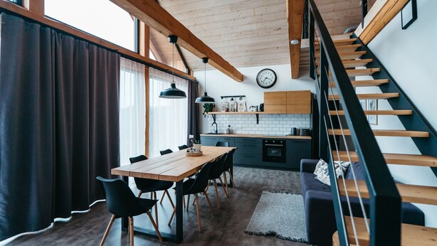 A modern kitchen with wooden beams, a dining area with a table and chairs, and a staircase. - Pernstejn Vpm019 in B Ovec (Býšovec)