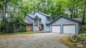 A two-story house with a stone foundation, a blue exterior, and a front porch. - Newly Renovated mountain top Ski House - Short Walk to Slopes (Somerset)