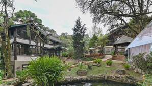 A traditional Japanese-style building with a koi pond in front.