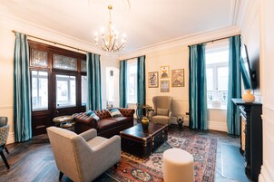 Grand Suite | Living area | 55-inch LED TV with satellite channels, DVD player