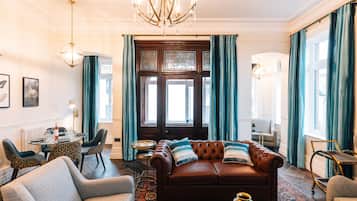 Grand Suite | Living area | 55-inch LED TV with satellite channels, DVD player