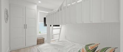 A bedroom with a bed, white wardrobe, and a view of the sea.