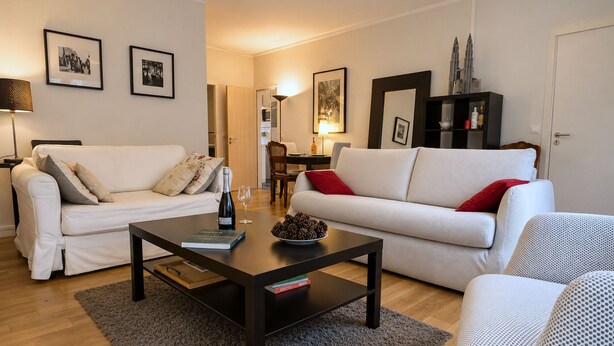 A living room with a sofa, a coffee table, and a bookshelf.