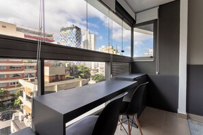 A modern apartment with a balcony, a desk, and a chair. - 360 VN Oscar Freire by Housi (São Paulo)