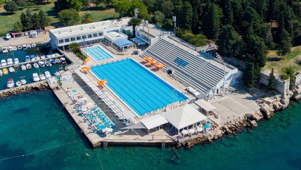 An aerial view of a coastal swimming pool complex with multiple pools, a marina, and surrounding residential areas. - A2- Luxury apt w big Balcony, 4 min Walk to Beach (Split)