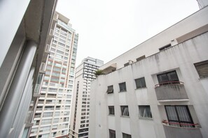 A high-rise building with multiple floors, large windows, and balconies. - 360 VN Frei Caneca by Housi (São Paulo)