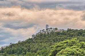 A mountainous landscape with a tower on a hill.