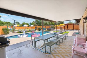 A covered outdoor area with a pool, lounge chairs, umbrellas, and picnic tables. - Sleeps 20! Pool, Basketball, Golf  Dream Resort (Scottsdale)