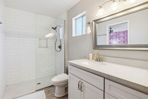 A modern bathroom with a shower, toilet, and vanity. - Sleeps 20! Pool, Basketball, Golf  Dream Resort (Scottsdale)
