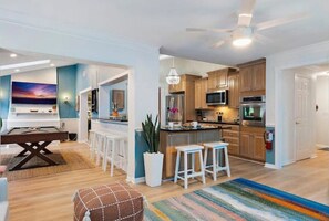 Enjoy meals in the dining area with a table and chairs, surrounded by a sofa and a rug.
