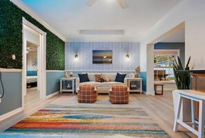 Relax in this inviting living room with a comfortable sofa set and artwork above.