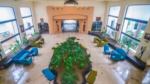 A lobby with a central garden, seating areas, and large windows. - Yasmine Beach - Families and Couples (Hammamet)