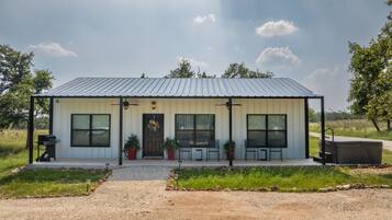 Situated in a rural setting, this charming home offers a peaceful retreat with a front porch and entrance.