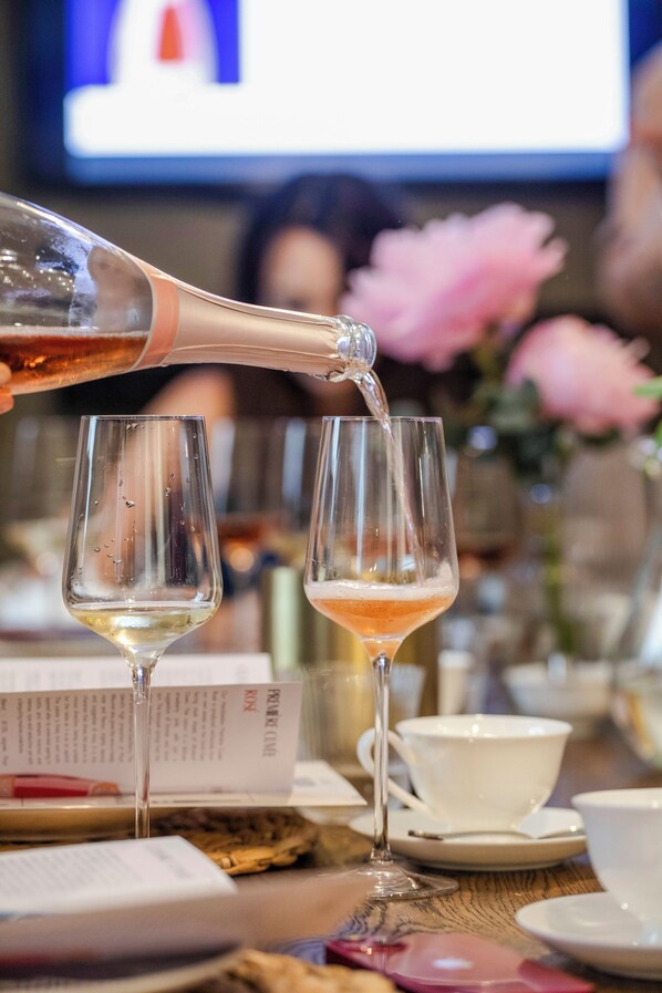 A bottle being poured into a glass. - Henry's Townhouse (London)