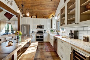 Enjoy meals in the kitchen's dining area with a wooden table and chairs.