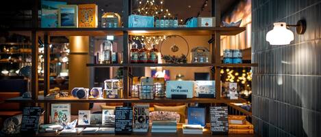A well-lit bookstore with shelves of books, a sign for 'SUB & POP', and a 'KAPTS DINNER' sign.