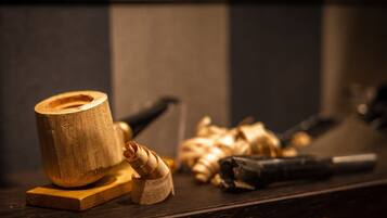 A wooden surface with a cylindrical object, a rolled-up item, and a few other indistinct objects.