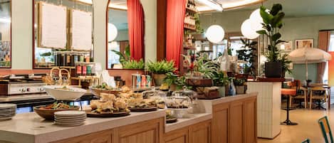 A restaurant with a wooden counter, menu boards, and a 'Winnie' sign.