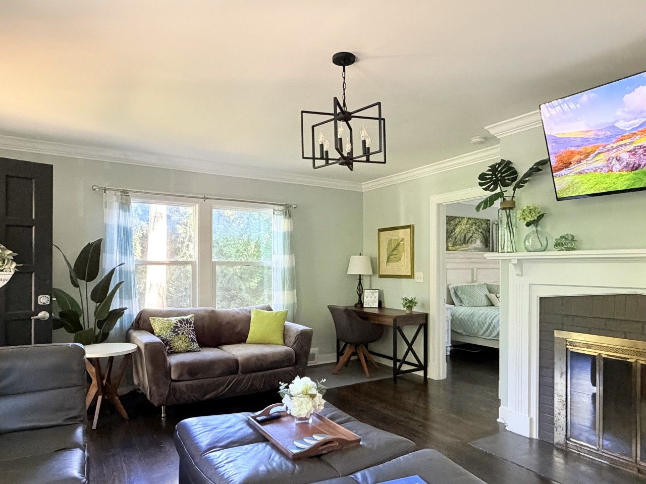 A living room with a fireplace, a television, and a comfortable seating area.