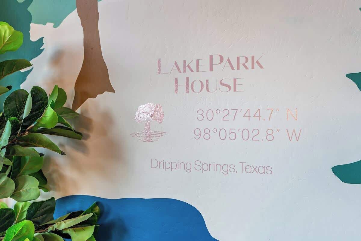 A sign with 'LakePark House' and coordinates for Dripping Springs, Texas.