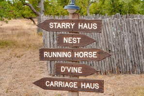 Explore the local area with our convenient signpost, pointing the way to nearby attractions like Starry Haus, Nest, Running Horse, D'Vine, and Carriage Haus.