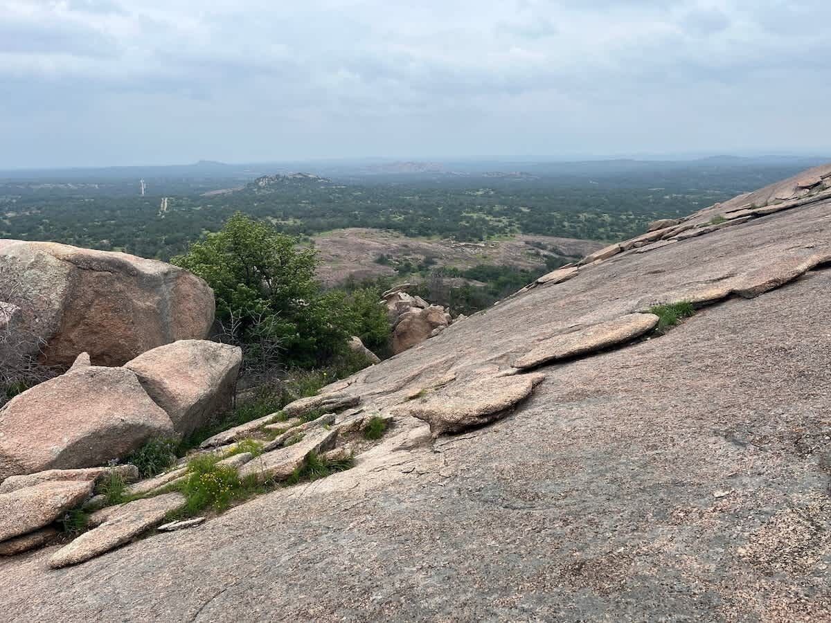 A rocky landscape with large boulders and sparse vegetation.
