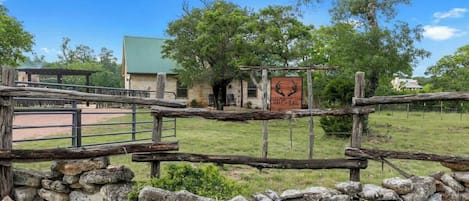 A rustic stone wall with a sign reading "3797" and a wooden fence.