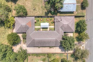 An aerial view of a modern building with a symmetrical roof and a central courtyard.