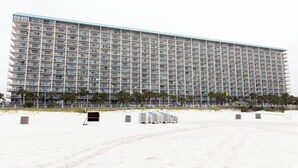 A large, multi-story hotel with numerous balconies and a flat roof.
