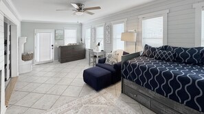 A bedroom with a large bed, a dresser, a desk, and a chair. - Barefoot Beach: Spectacular Family Beach Retreat! (Atlantic Beach)