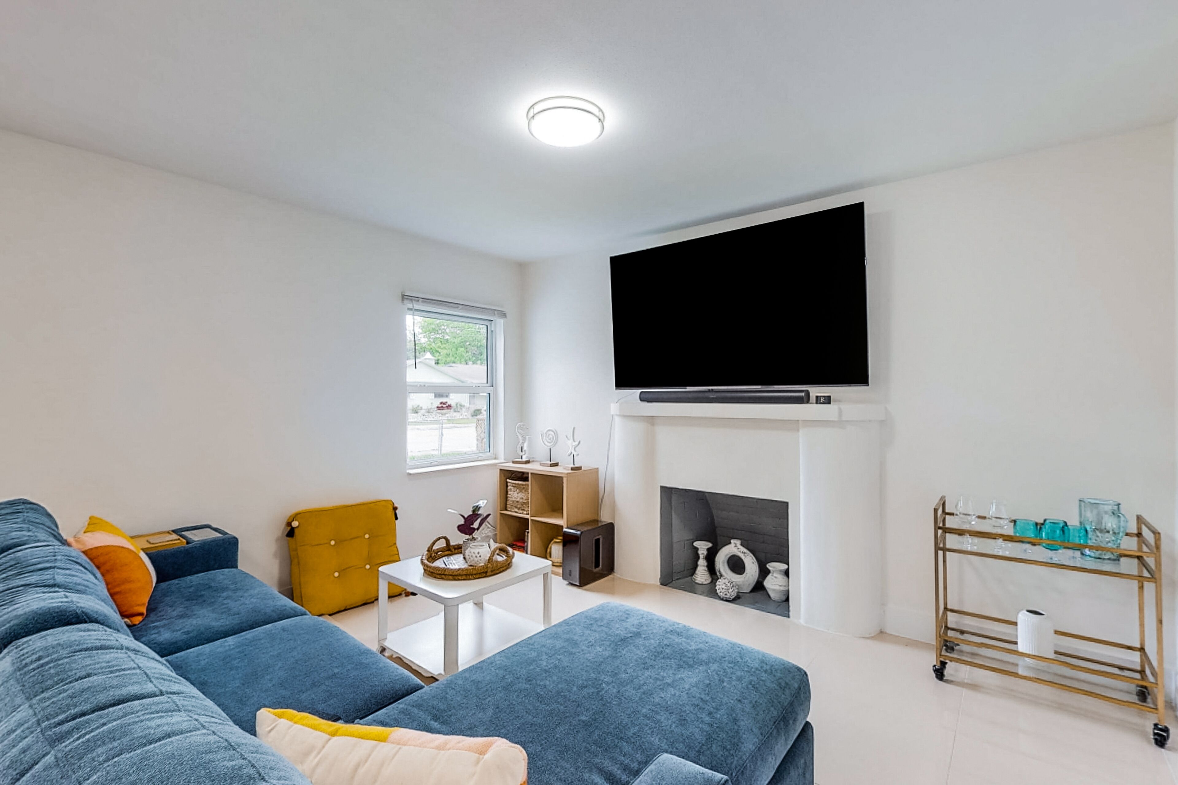 Modern charmer with wood fireplace, central location, & AC