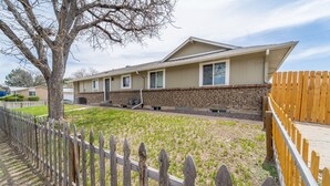 A two-story building with a brick facade and a flat roof. - NO exta fees, Beautiful half duplex 3br, 2ba, w/gym, office and fenced in yard. (Aurora)