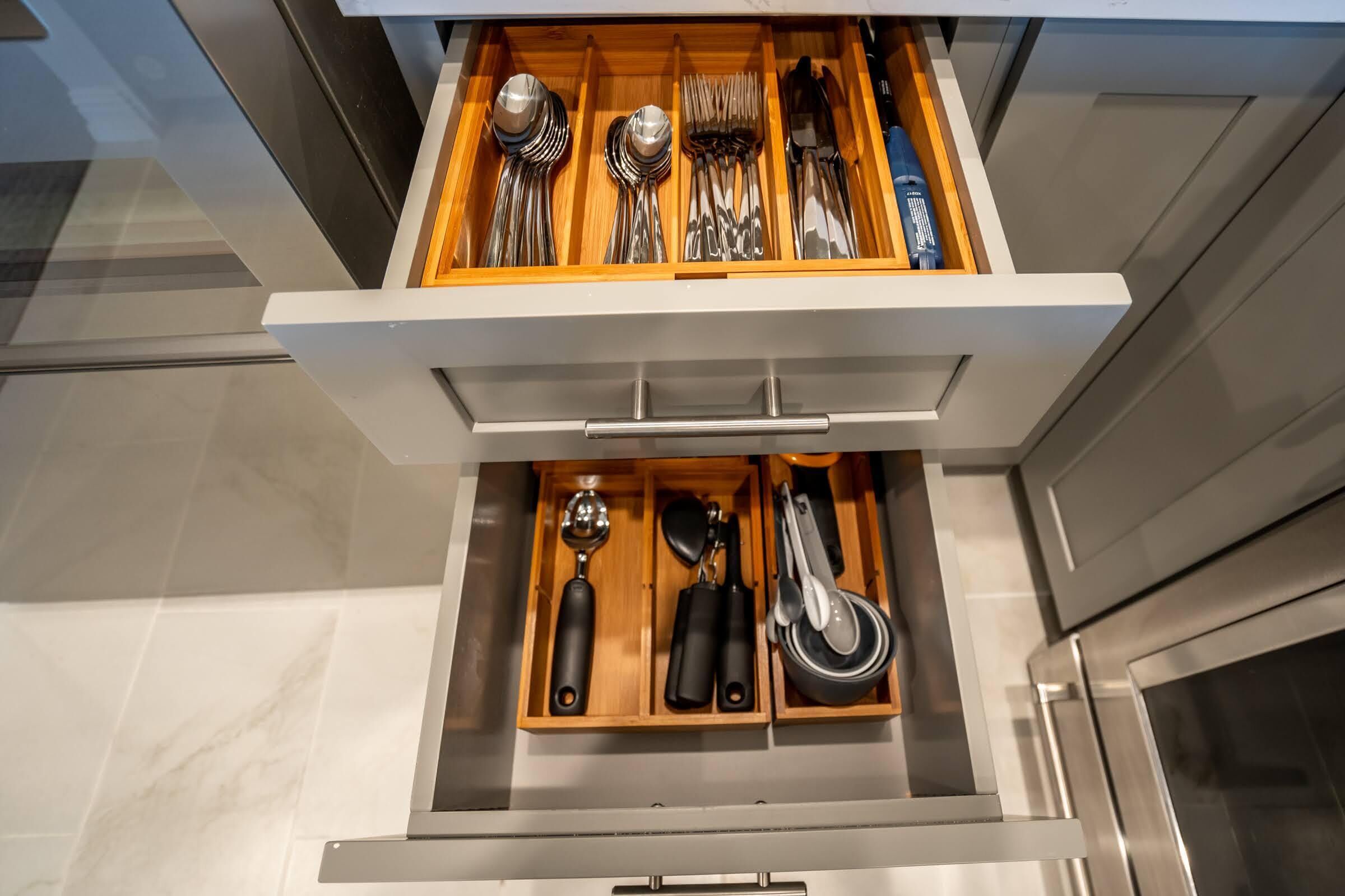 A drawer with utensils and kitchen tools.
