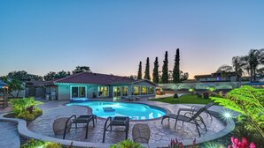 A pool area with lounge chairs, a hot tub, and a well-maintained garden. - Luxe Family Home in Bonita w/ Private Pool & Spa! (Bonita)