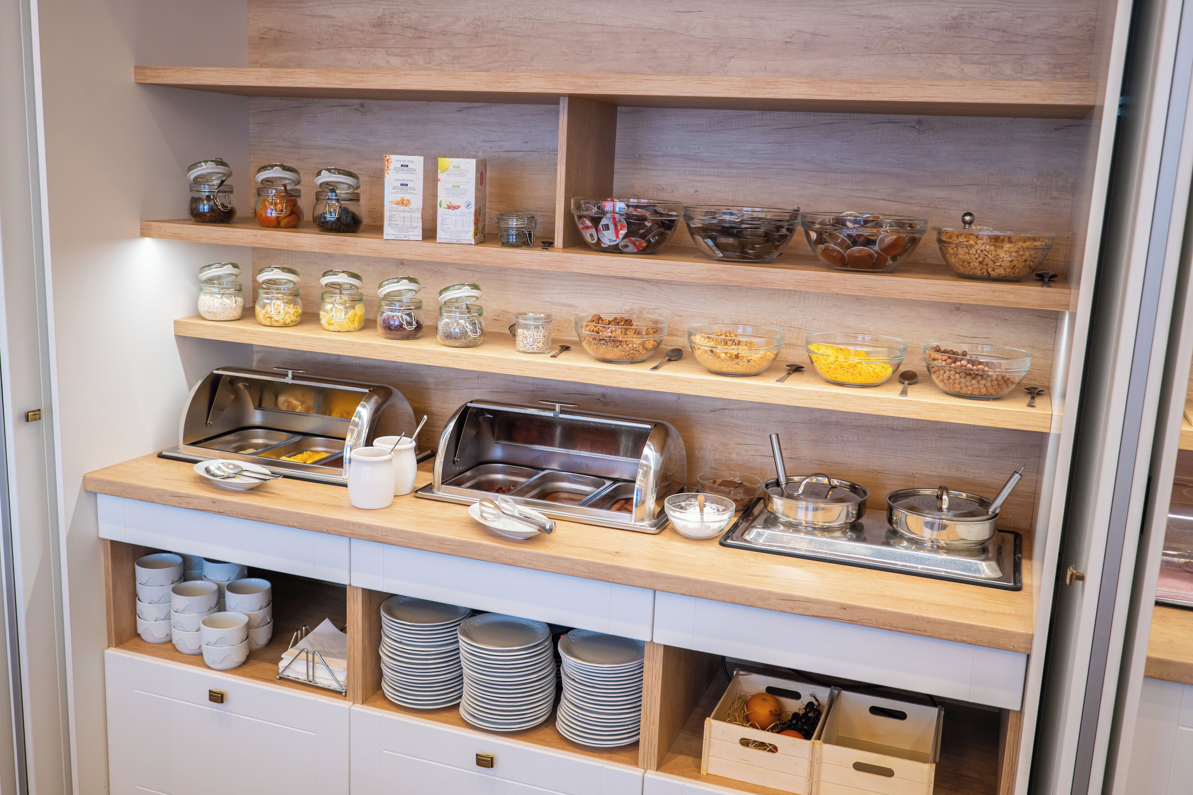 Mesa de buffet com diversos alimentos e utensílios.