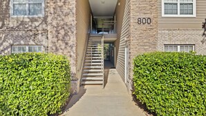 A two-story building with a central staircase, a garage door, and a number '800' on the side. - Ball fields! OWA! & Near the Beach! (Foley)